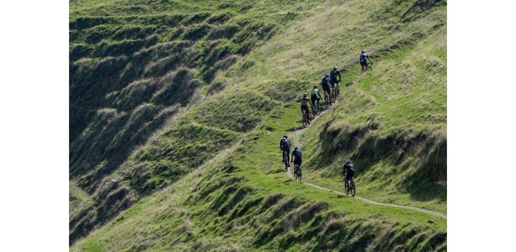 gravel bike riders climb singletrack hill during Rock Cobbler in California