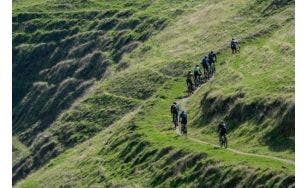gravel bike riders climb singletrack hill during Rock Cobbler in California